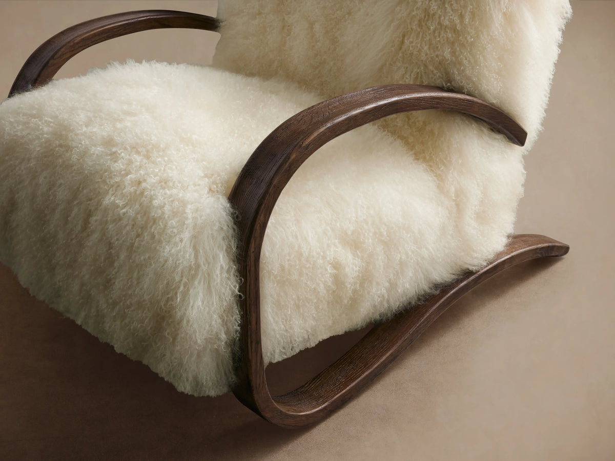 Allora Mongolian Shearling Chair: Cream fluffy shearling upholstery on a dark mocha curved wood frame, front view.