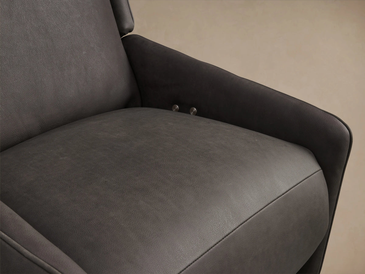 Hurley Leather Motion Swivel Chair in dark brown leather, front view. Features high backrest, cushioned seat, and sleek metal swivel base on wooden floor.