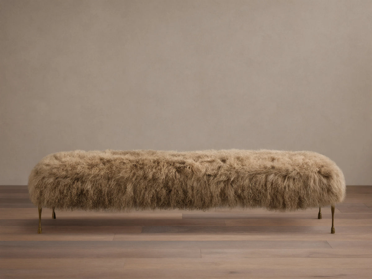 Front view of the Tan Gwen Mongolian Shearling Bench, covered in textured shearling, with four slender hand-painted brass finish legs.