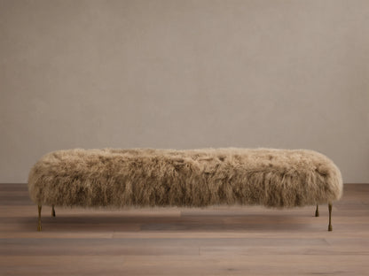 Front view of the Tan Gwen Mongolian Shearling Bench, covered in textured shearling, with four slender hand-painted brass finish legs.