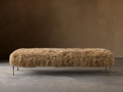 Front view of the Tan Gwen Mongolian Shearling Bench, covered in textured shearling, with four slender hand-painted brass finish legs.