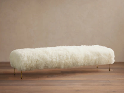 Front view of the cream Gwen Mongolian Shearling Bench with long shaggy fur and hand-painted brass-finish iron legs.