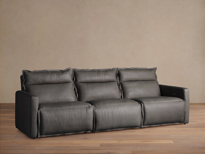A three-piece Rowland Leather Motion Modular Sofa, in dark leather, with left, armless, and right recliners, on a wooden floor.
