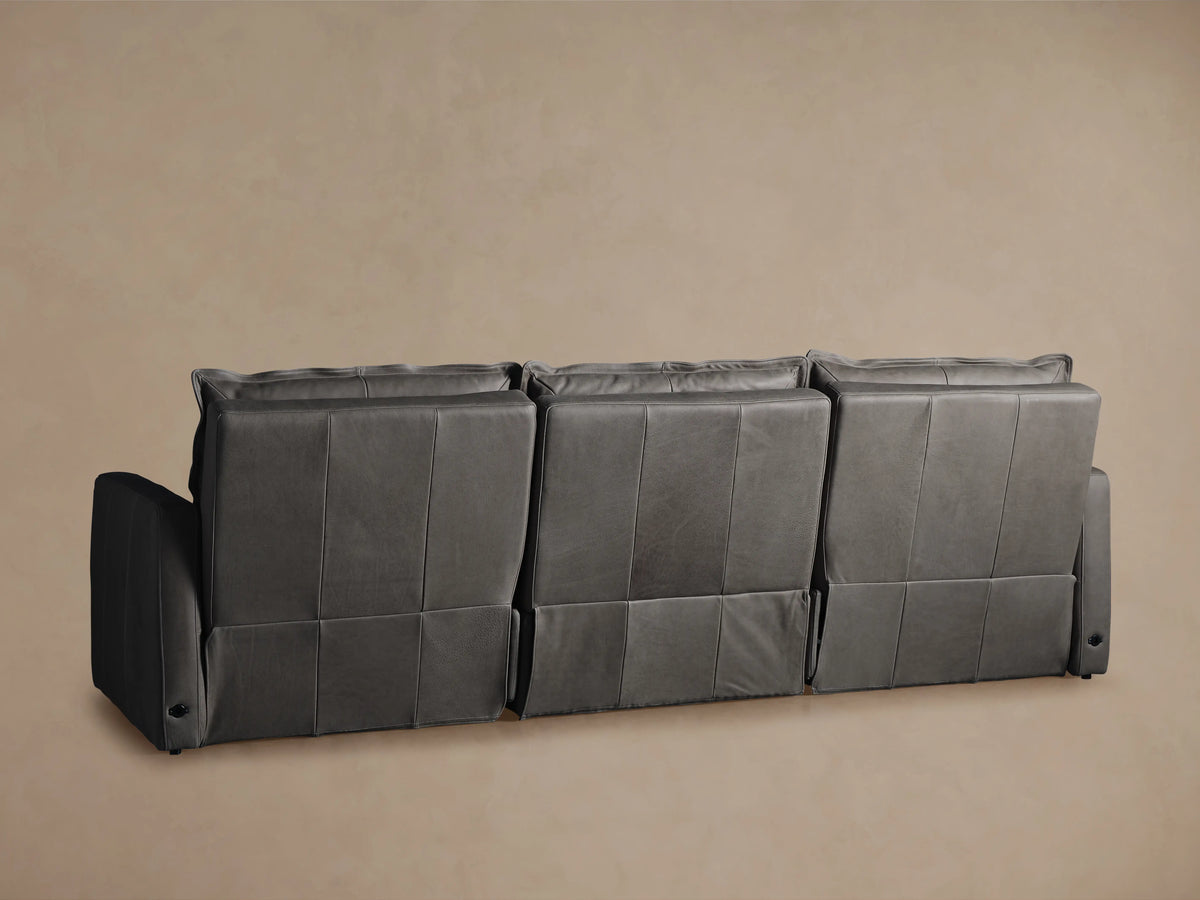 Rowland Leather Three-Piece Motion Modular Sofa in soft gray, featuring plush backrests and sturdy armrests, set against a neutral background.