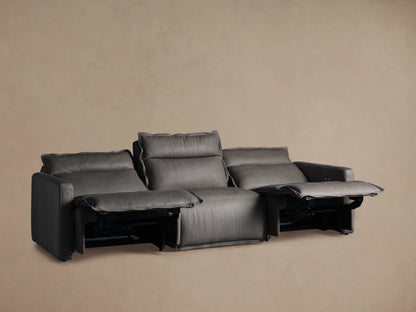 Back view of Rowland Leather Three-Piece Motion Modular Sofa in dark leather, showing three sections with stitched panels and padded backrests.