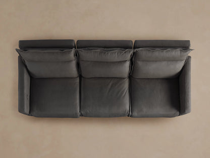 Rowland Leather Three-Piece Motion Modular Sofa in dark brown, with left and right recliners extended on a beige background.