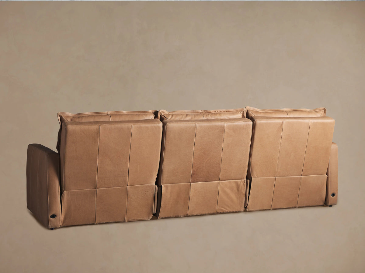 Rowland Leather Three-Piece Motion Modular Sofa in tan leather, featuring padded seat and backrests, with visible stitching on broad armrests.