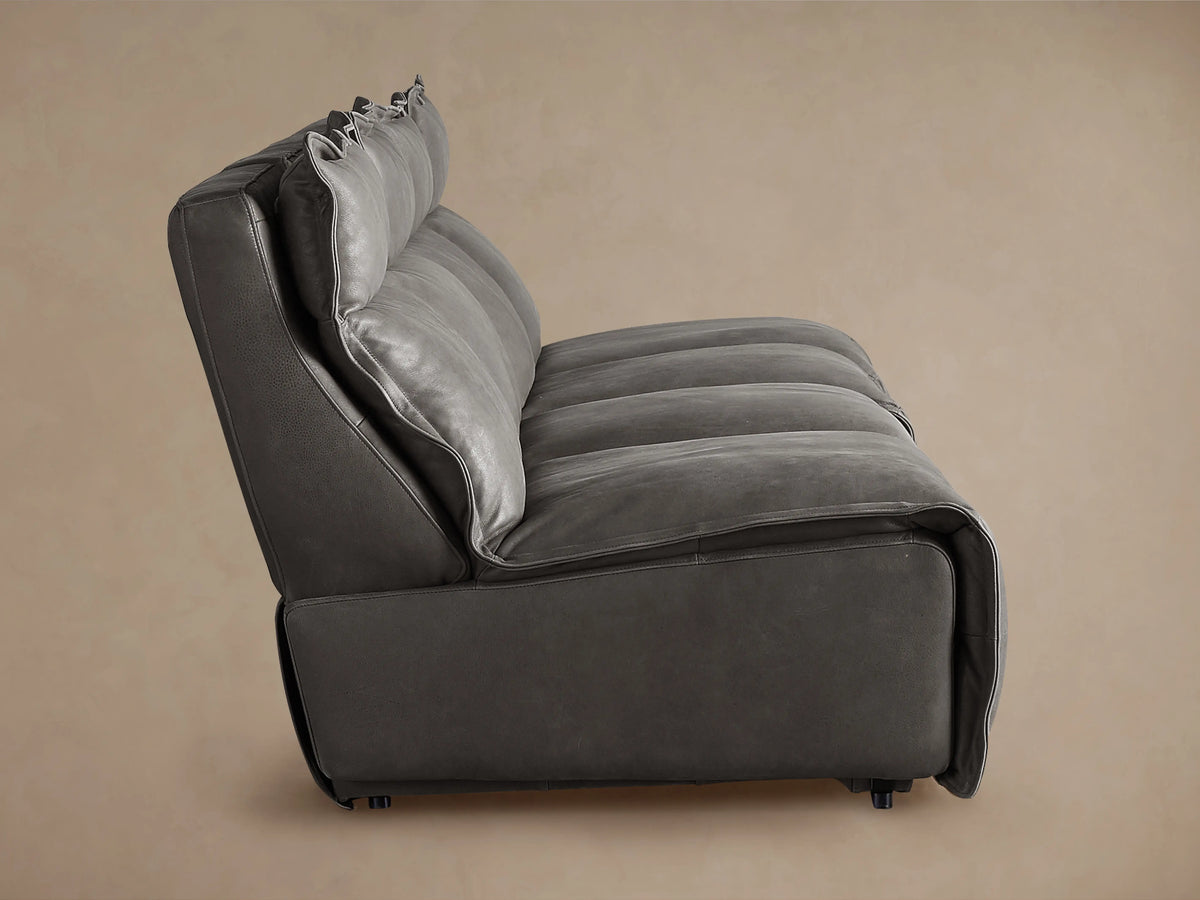 Rowland Leather Four-Piece Armless Motion Modular Sofa in side view, showcasing dark gray leather with plush, tufted back and seat cushions.
