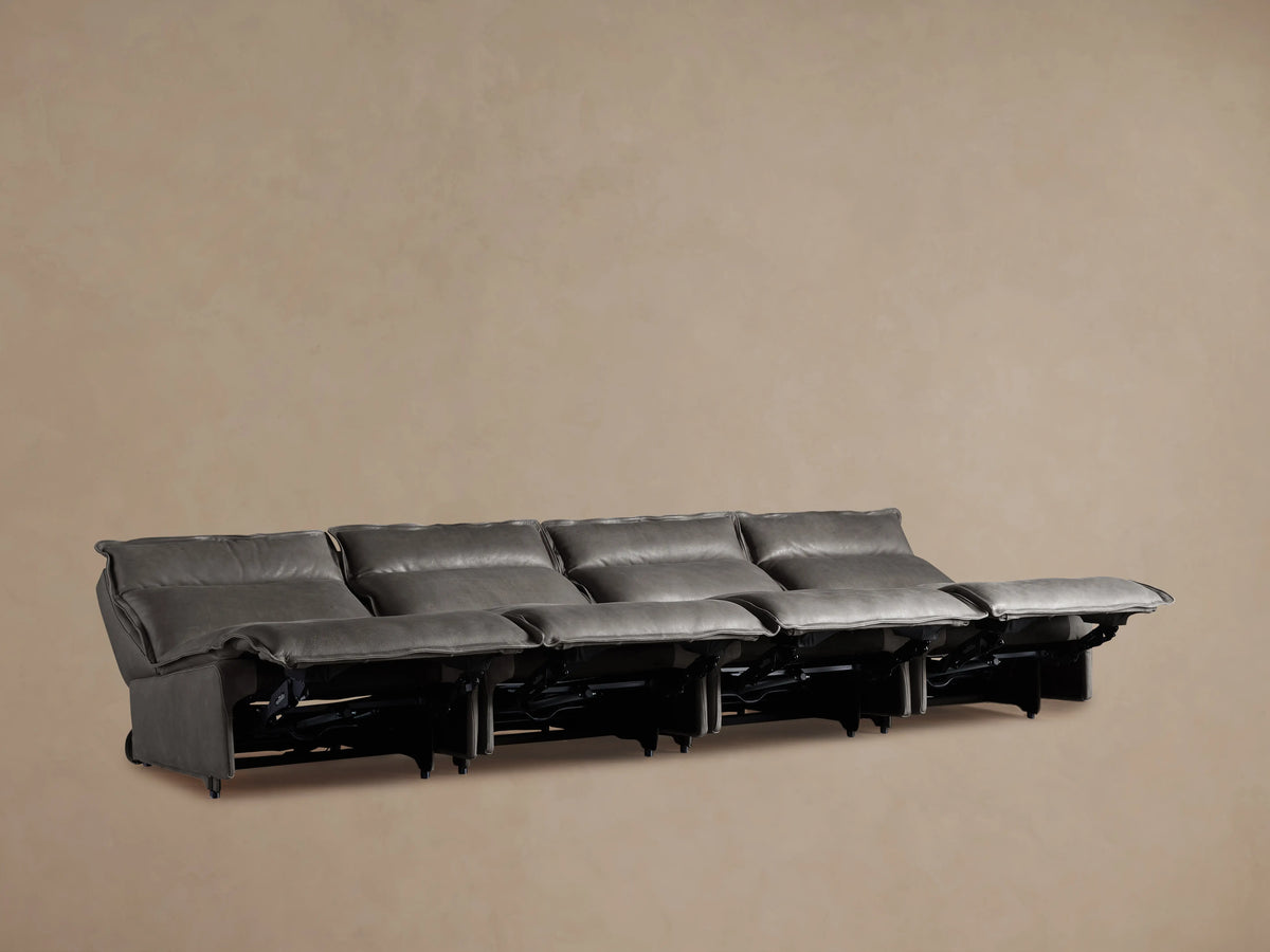 Rowland Leather Four-Piece Armless Motion Modular Sofa in dark brown leather, four recliners aligned, set on wooden floor.