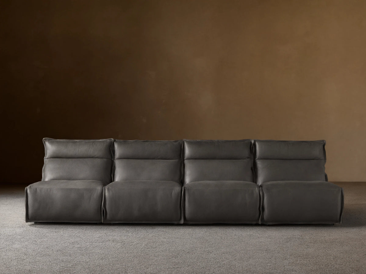 Rowland Leather Four-Piece Armless Motion Modular Sofa in dark brown leather, four recliners aligned, set on wooden floor.