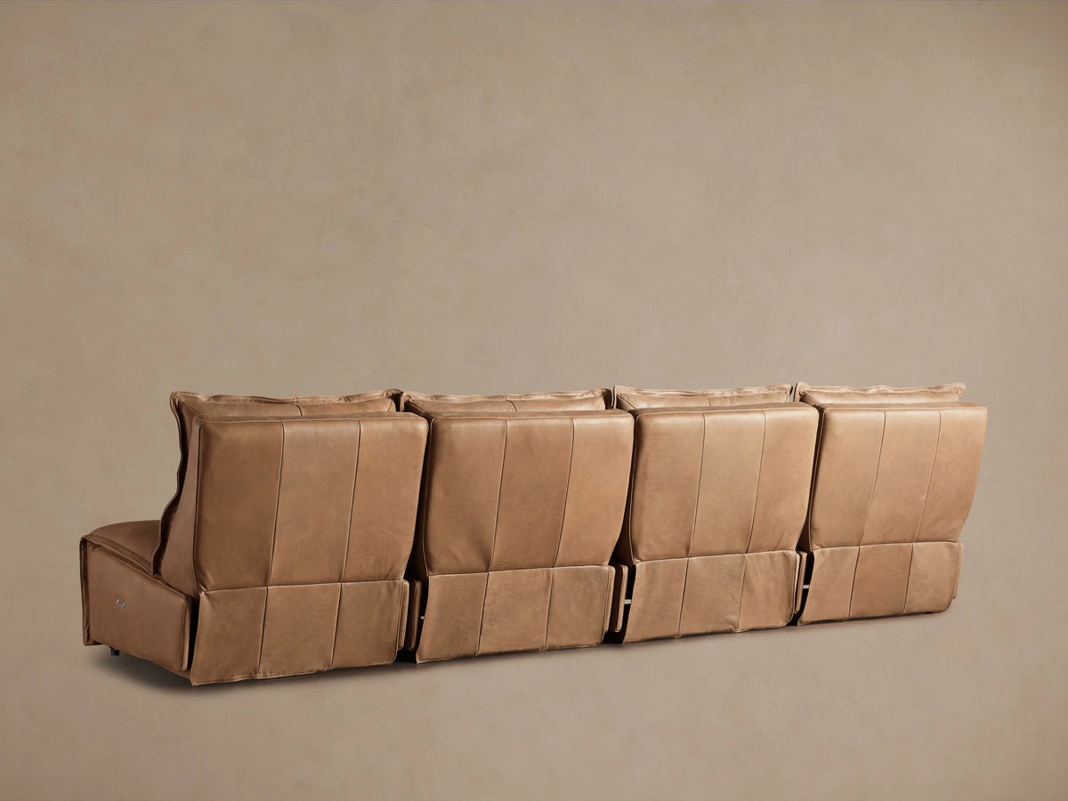 Rowland Leather Four-Piece Armless Motion Modular Sofa in tan leather, viewed from the back, showing four connected sections without visible connectors.