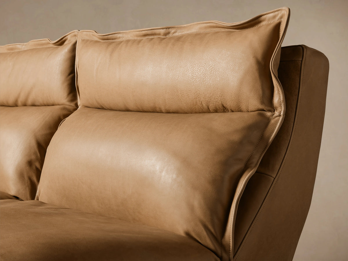 Rowland Leather Five-Piece Motion Corner Sectional in tan leather, consisting of five sections arranged in an L-shape on a wooden floor.