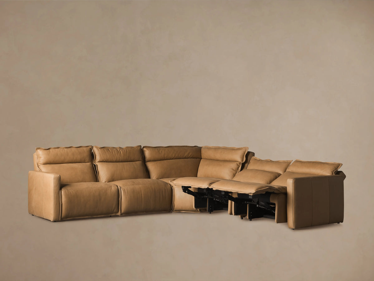 Rowland Leather Five-Piece Motion Corner Sectional in tan leather, featuring five cushioned seats with one reclined and extended footrest on the right.