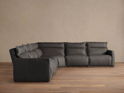 Rowland Leather Six-Piece Motion Sectional in a corner setup on wooden floor, dark leather upholstery, soft cushions, and plush backrests.