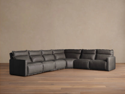 Rowland Leather Six-Piece Motion Sectional in a corner setup on wooden floor, dark leather upholstery, soft cushions, and plush backrests.