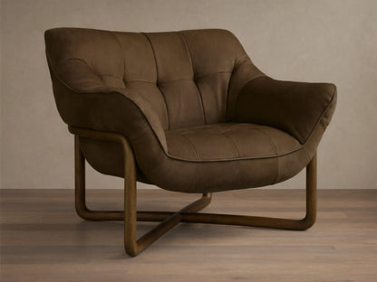 Front view of a dark brown distressed leather lounge chair with deep tufting, piping, and a curved wooden frame.