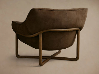 Close-up of a rich brown tufted lounge chair with plush, velvet-like fabric, showing deep creases and piped edges.