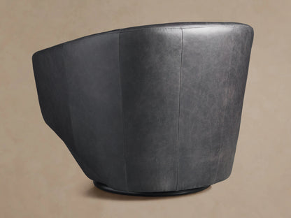 Pelton Leather Swivel Chair, front view. Dark gray distressed leather, rounded bucket design with a black swivel base.