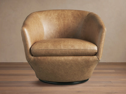 Pelton Leather Swivel Chair. Distressed tan leather barrel armchair with visible stitching, a plump seat, and a black swivel base.