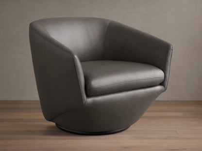 Front-side view of the dark gray Pelton Leather Swivel Chair, showing its rounded shape, deep seat, and dark swivel base.