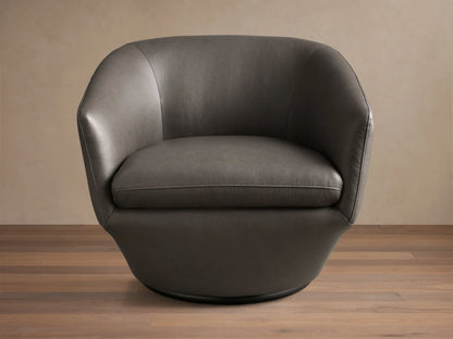Front-side view of the dark gray Pelton Leather Swivel Chair, showing its rounded shape, deep seat, and dark swivel base.