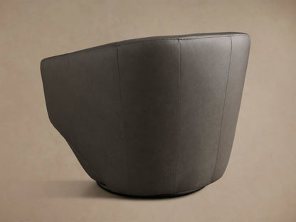 Side profile of a dark gray Pelton Leather Swivel Chair, highlighting its smooth, curved design and armrest.