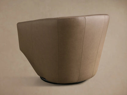 Close-up of the taupe leather on the Pelton Leather Swivel Chair, showing smooth texture and fine stitching along the curved arm and back.