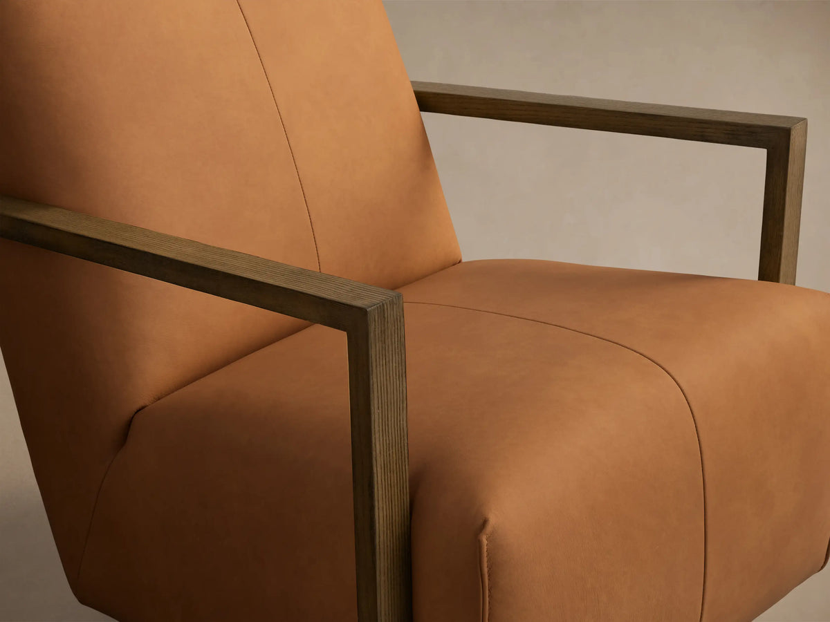 Front view of the Tan Walsh Leather Swivel Glider with dark wood arms and a black swivel base.
