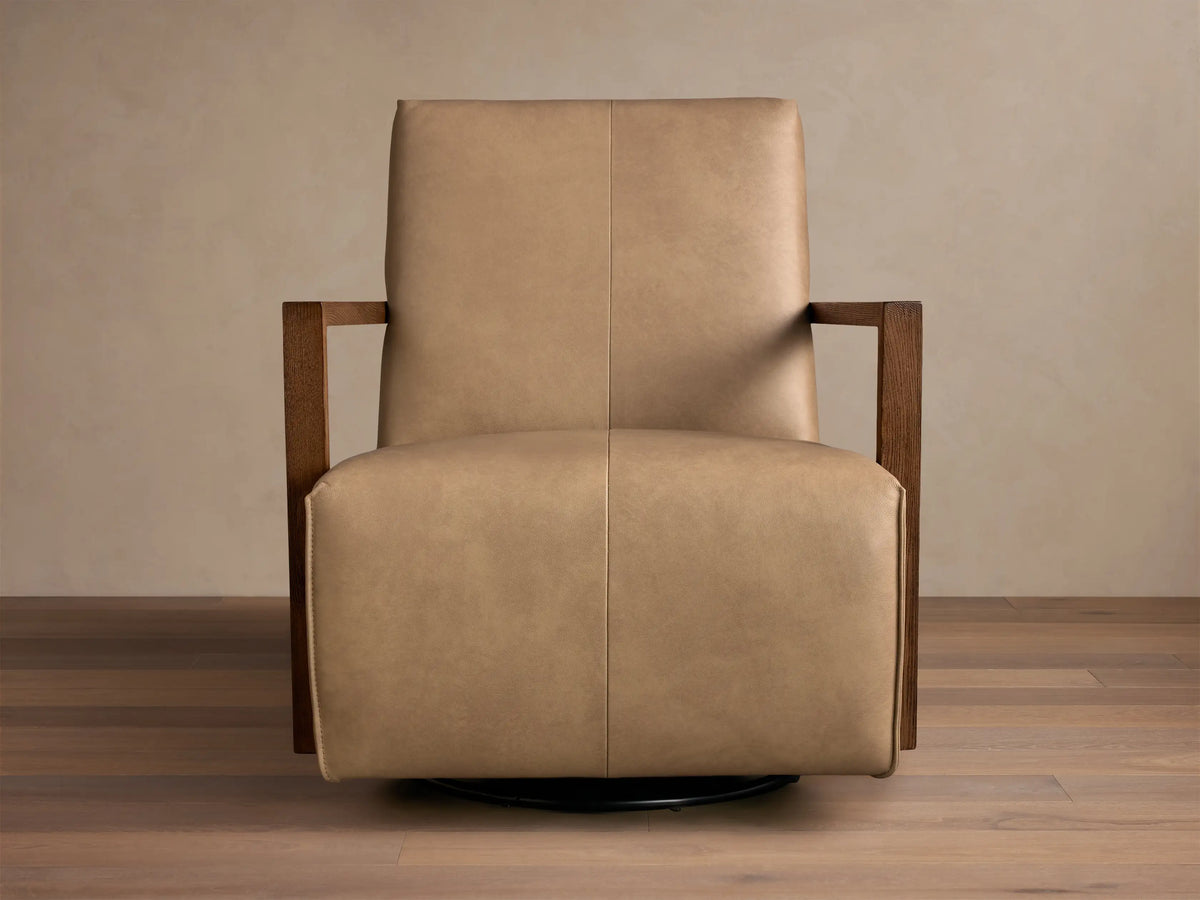 Front view of the tan Walsh Leather Swivel Glider with dark wooden armrests and a black swivel base.