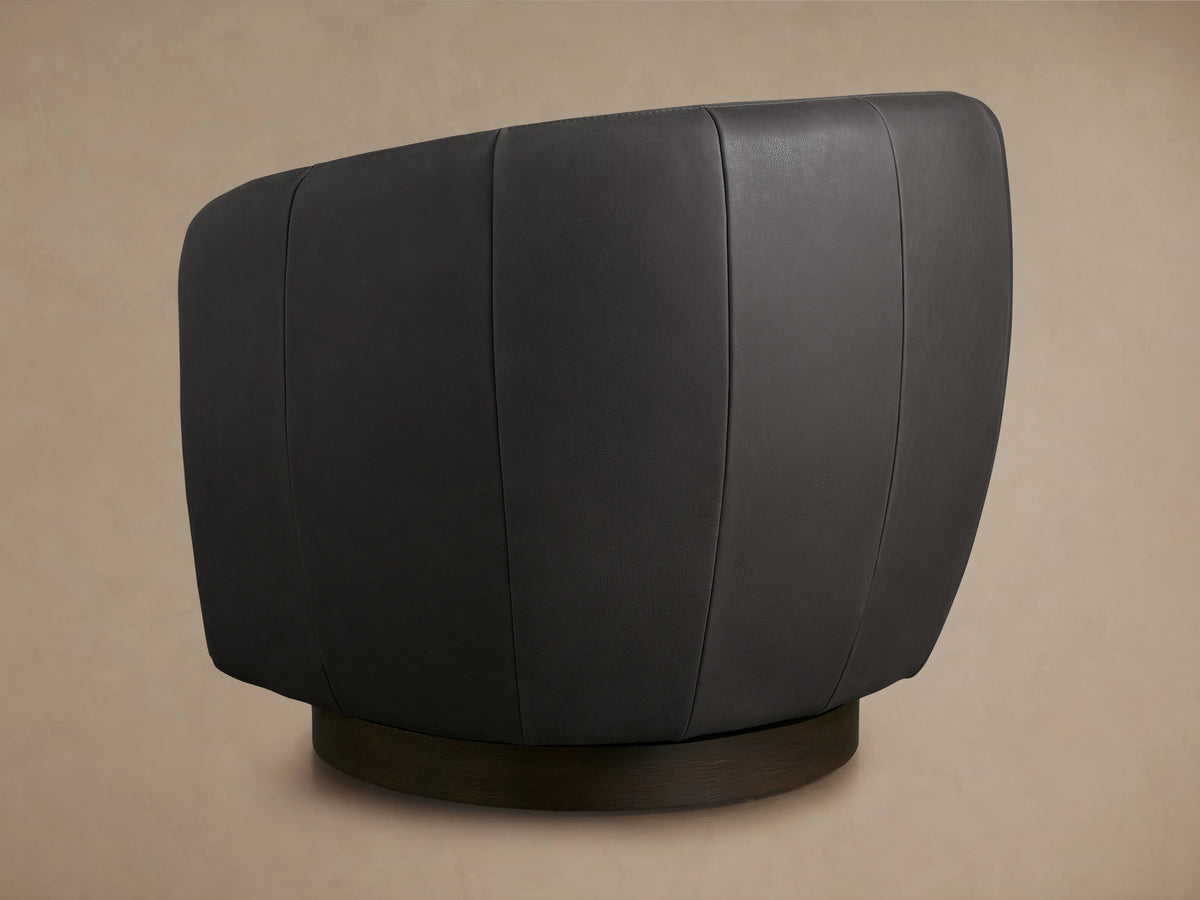 Cerrito Leather Swivel Chair in dark gray leather, close-up of curved armrest and seat cushion, showing smooth texture and stitching.