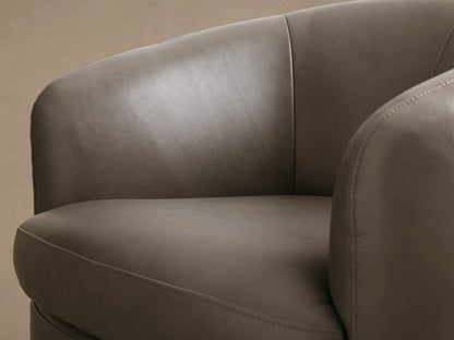 Close-up of the taupe leather Cerrito Leather Swivel Chair, showing the curved armrest and seat with visible stitching.