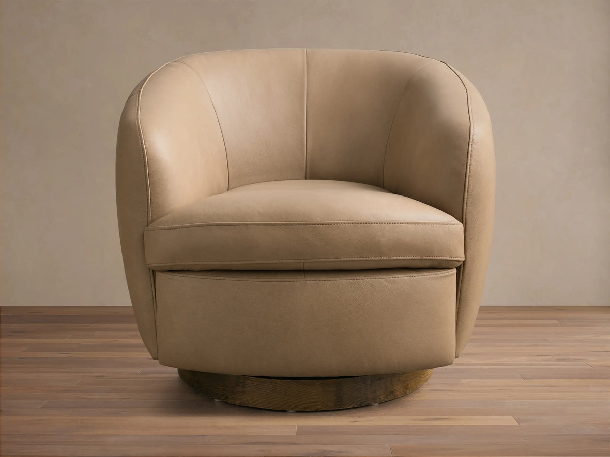 Front view of a tan Cerrito Leather Swivel Chair featuring a rounded design and a dark wooden swivel base.