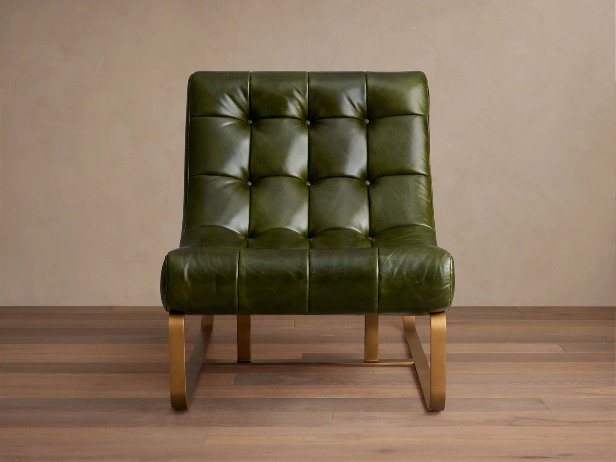 Brown Callaway Leather Chair with tufted leather cushions, low back, and exposed black metal frame from a front-side angle.
