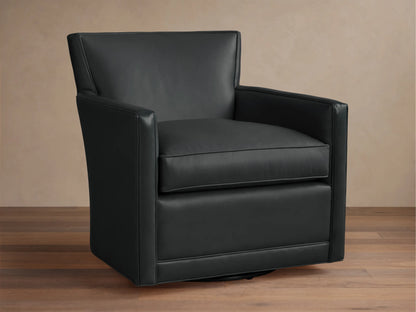 Black leather Rudy Swivel Chair with a modern, clean design, square arms, shown on a wooden floor against a light wall.