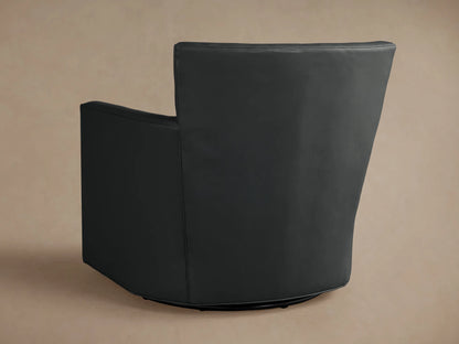 Close-up of a dark grey Rudy Leather Swivel Chair, showing the square armrest and piped seat cushion from an angled view.