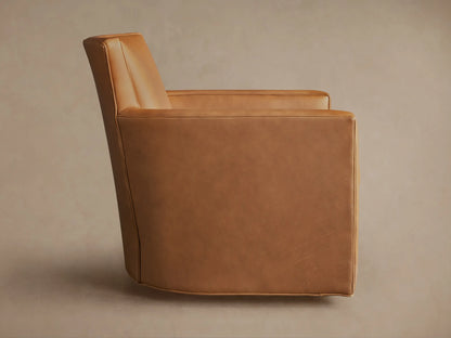 Back of a Rudy Leather Swivel Chair in caramel brown, featuring clean lines, wide back, subtle arms, and dark swivel base.
