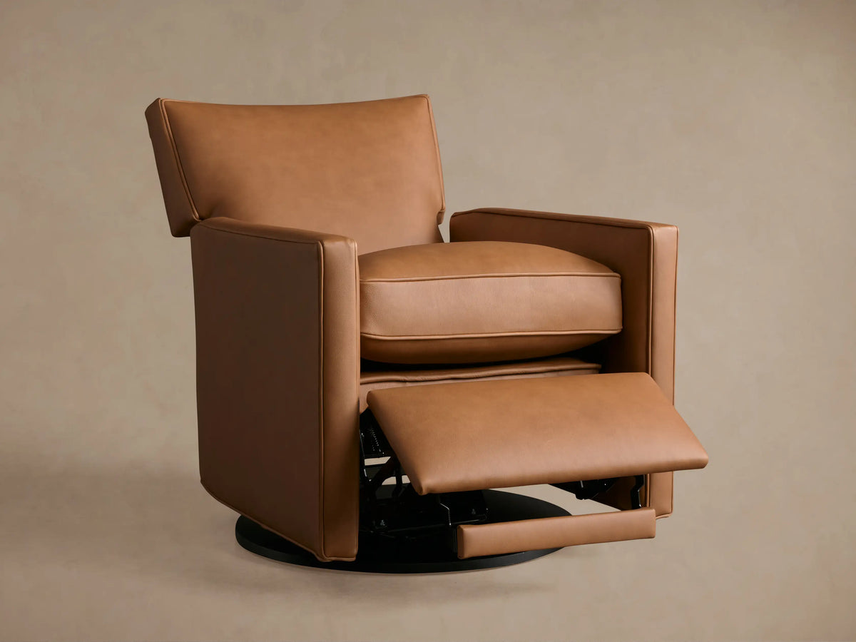 Tan leather Rudy Swivel Recliner, high-angle close-up. Seat, extended footrest, and armrest reveal smooth, warm brown leather.