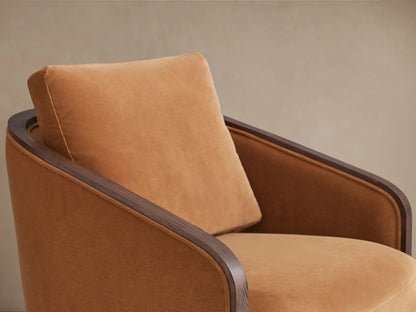 Pomona Swivel Chair with curved back in warm camel fabric, dark oak wood trim, and circular swivel base, angled from rear.