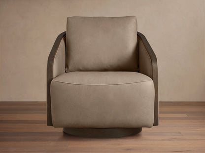 Pomona Leather Swivel Chair in light brown leather with exposed oak edges, featuring a plush seat and back cushion on a wooden floor.