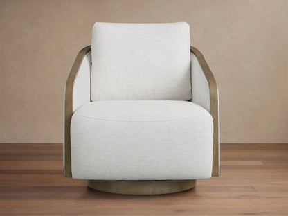 Front view of the beige Pomona Swivel Chair with exposed oak arms and swivel base, on a light rug.