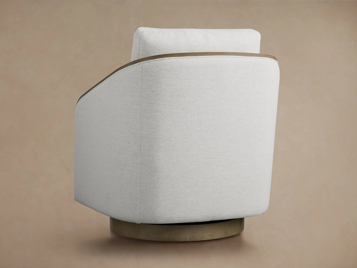 Pomona Swivel Chair with light fabric cushions, exposed oak edges on arms and base, showing a close-up of backrest.