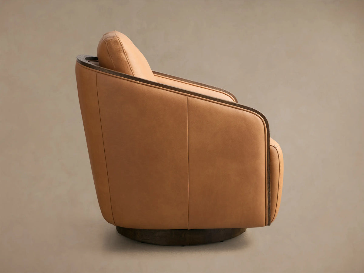 Front view of the tan Pomona Leather Swivel Chair with exposed dark oak armrests and matching swivel base.