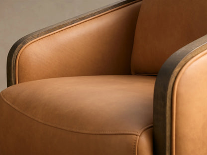 Side profile of the tan leather Pomona Leather Swivel Chair with dark oak trim and a round wooden swivel base.