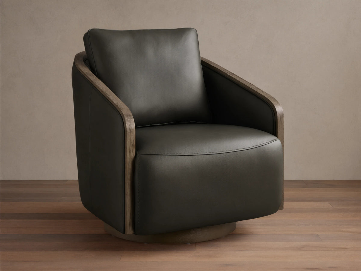 Front view of the dark olive green leather Pomona Leather Swivel Chair with exposed oak arms and a round swivel base.