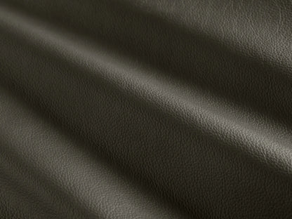 Side profile of the deep charcoal Pomona Leather Swivel Chair, with exposed oak edges and a visible swivel base.