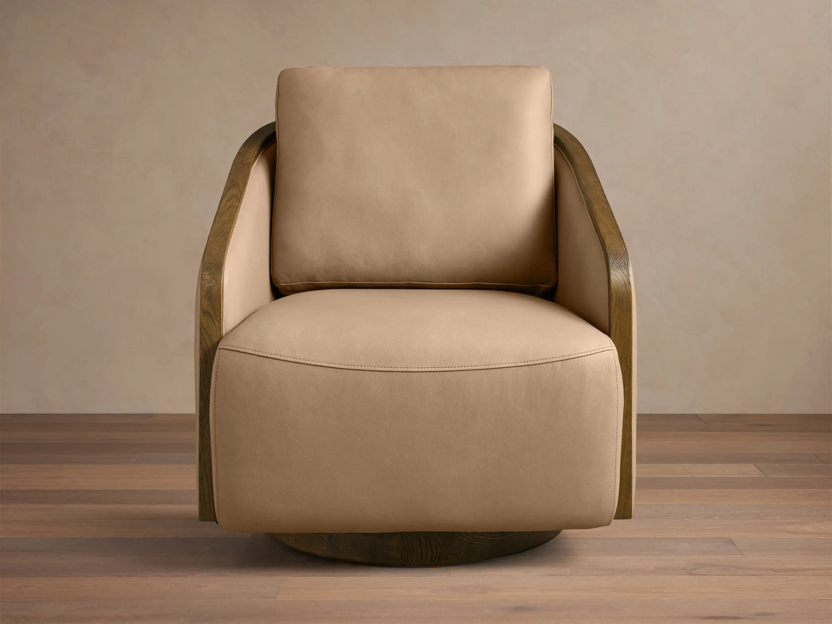 Front view of the tan Pomona Leather Swivel Chair, featuring dark exposed oak armrests and a matching swivel base.