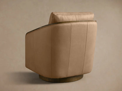 Close-up of the tan leather seat and dark oak armrest on the Pomona Leather Swivel Chair.