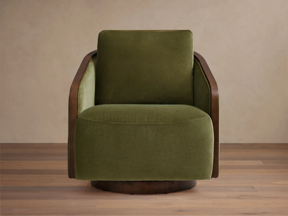 Angled front view of the beige Pomona Swivel Chair with exposed oak arms and swivel base.