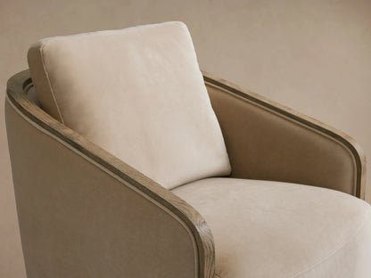 Pomona Swivel Chair in neutral beige with soft cushions and exposed oak edges on arms and base, on wooden floor.