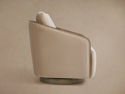 Pomona Swivel Chair with neutral-toned cushion and exposed oak edges on arms, set against a matching background.